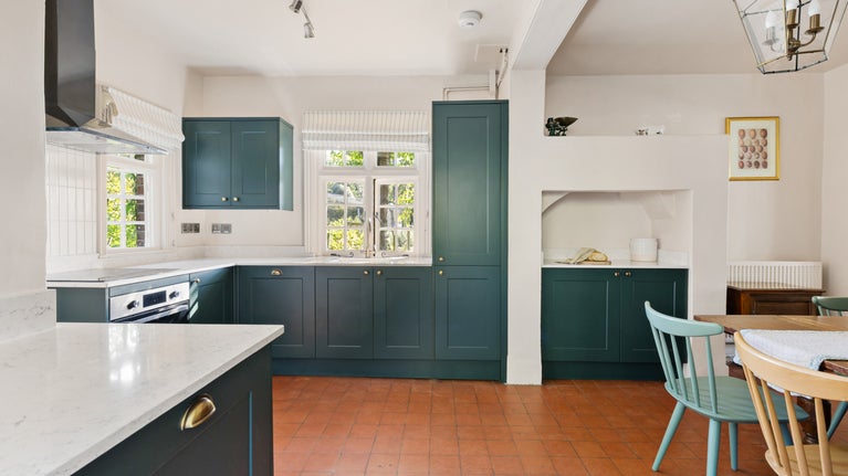 The kitchen with dining table at Polesden Garden Cottage, Surrey